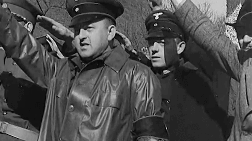 photo of nazis saluting as tanks roll by